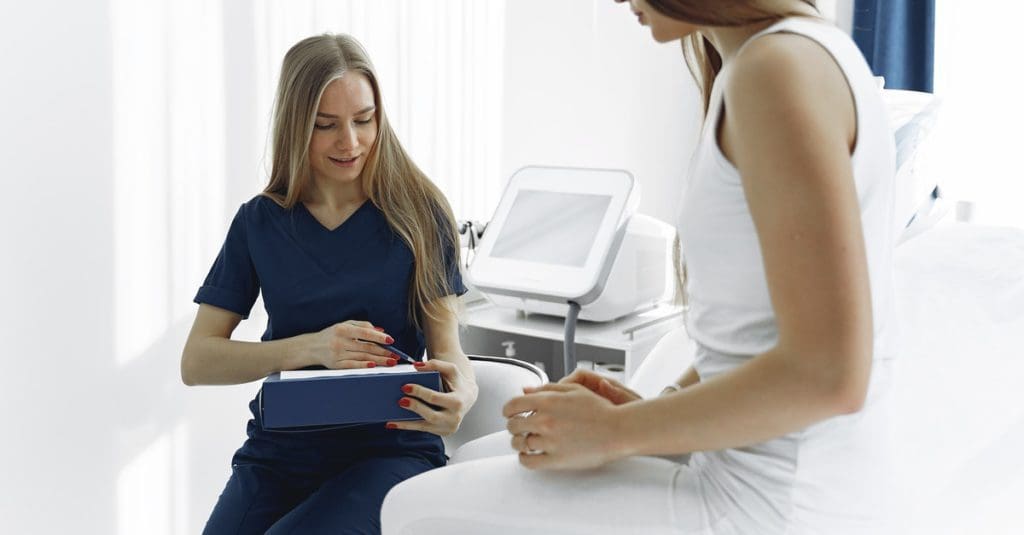 How Is CBD Beneficial For Cancer?, #1 USA Cannabidiol Blog This image shows a cancer patient and a nurse. This is related to the topic CBD for cancer patients.